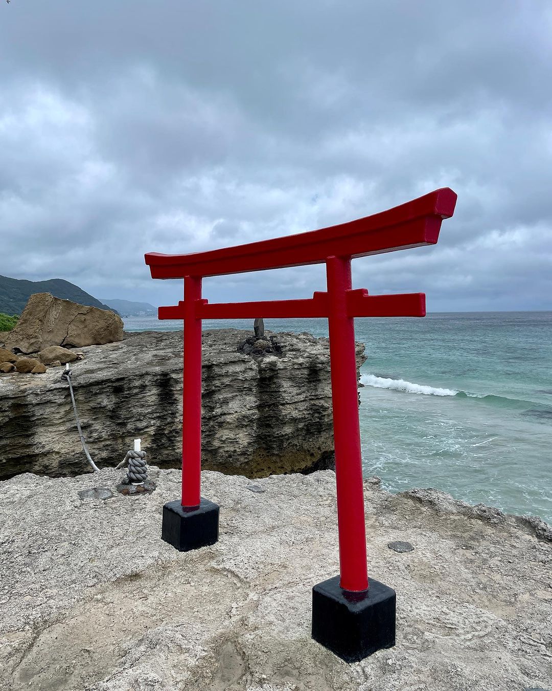 Torii Gate placed at the edge of the rugged coastline of Izu Peninsula