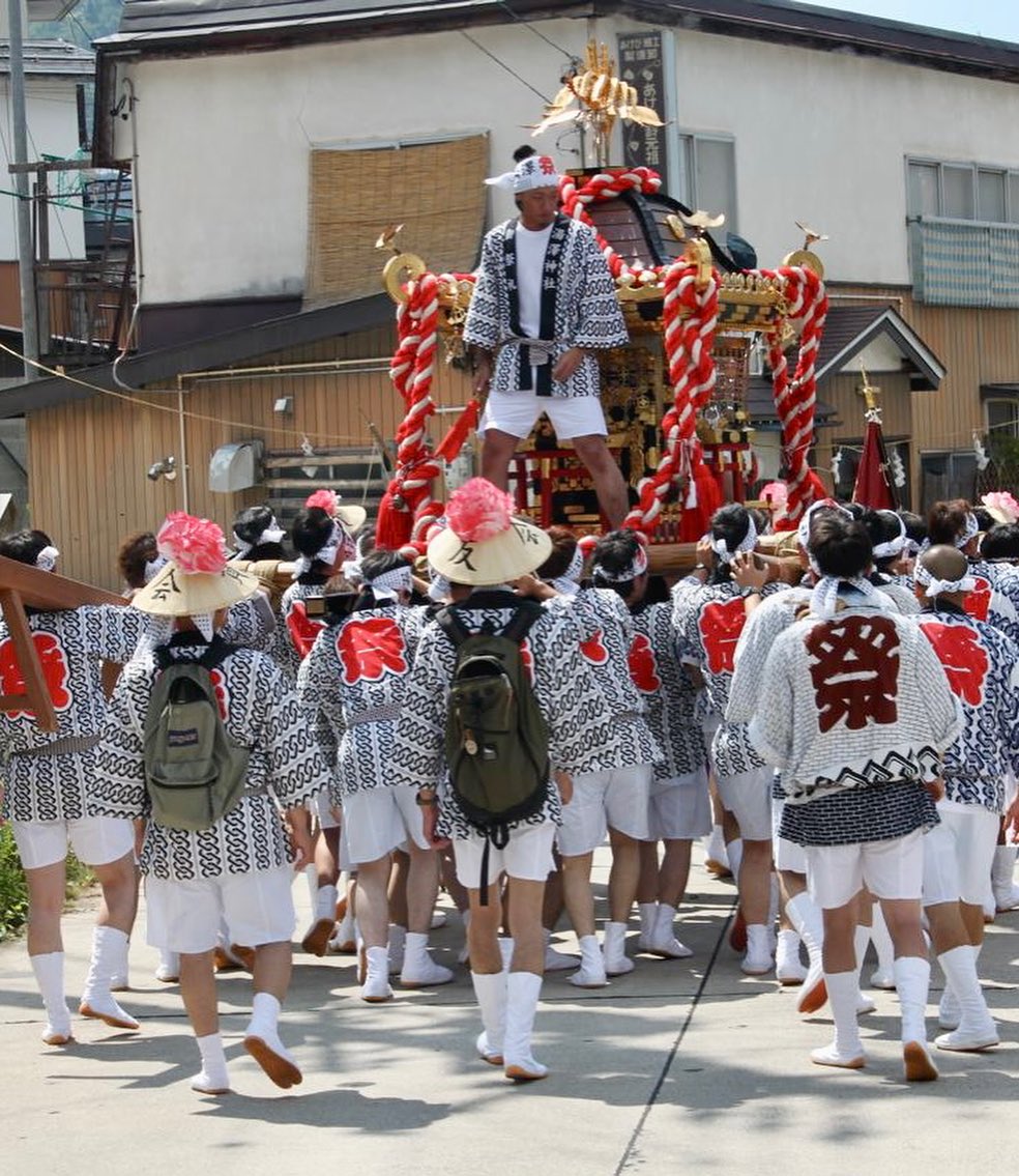 Procession of Omikoshi making way through the village of Nozawa